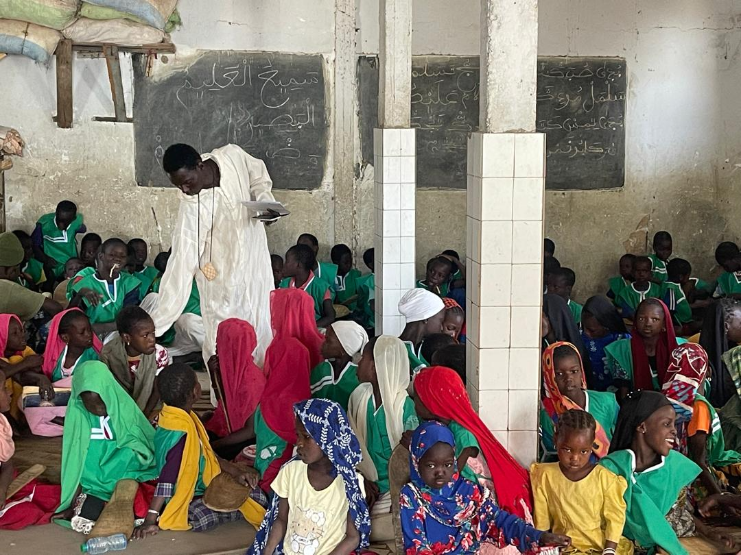 Un maître coranique enseigne à des élèves assis au sol dans un daara de Touba